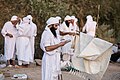 Example of a drabsha (right), with a priest reciting from a prayerbook during a masbuta ritual by the Karun River in Ahvaz, Iran (center)