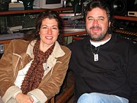 Singers Vince Gill and Amy Grant, seated next to each other in a recording studio.