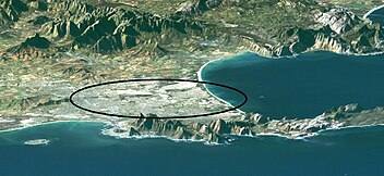 Landsat image of Cape Town and environs, looking roughly east. Cape Peninsula in the foreground; Table Bay with Robben Island to the left; False Bay with Seal Island (small white dot) to the right. The mountains of the Boland to the rear. The oval (long axis about 25 km) roughly encompasses the Cape Flats. Capeflats.jpg