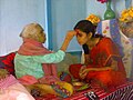 Image 4Senior offering Dashain Tika to junior (from Culture of Nepal)