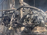 A civilian car thrown by the shock wave in the middle of the premises of a medical facility