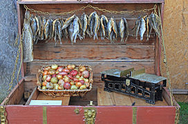 Onions and dried fish for sale on a farmer's roadside stand.