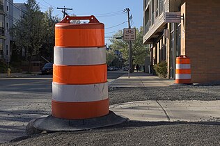 Construction barrels (traffic drums) on sidewalk in Medford, Massachusetts.