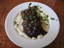 Grillades and grits topped with scallions at a restaurant in New Orleans GreenGoddessGritsGrillades.JPG