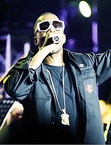 West holding a microphone in 2007