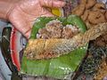 Kao hnyin baung - cooked glutinous rice with fried fish on a banana leaf.jpg