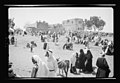 Palestinian Muslims at Mejdal, in Mandatory Palestine in April 1943, with Maqam al-Imam al-Husayn in the background.