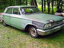 A weathered Ford 300. In the absence of a front fender badge, this 4-door sedan likely came equipped with the standard OHV inline-6 engine. Ford 300.JPG