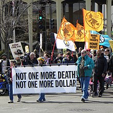 Marchers with flags and banners on a sunny day