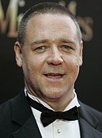 Photo of a man wearing a tuxedo and a black bow tie.