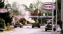 damaged JNA tanks on the road