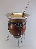 Calabash used as a container for drinking mate with a metal bombilla.