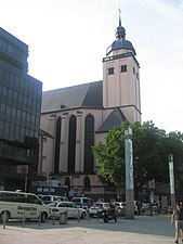 Clocher massif à base carrée, située au-dessus de l'abside d'une église et dominant une place.