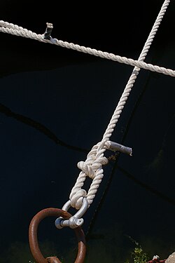 Iron eye with knotted rope at a pier of Risör, Norway