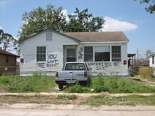 "You loot we shoot" painted on flood-damaged house in New Orleans (Apr 2006) NOEast18Ap06YouLootWeShootMazda.jpg