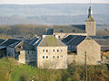 L'église vue du lieu-dit Sur les Monts. À l'avant-plan : l'ancienne maison seigneuriale de Nonancourt, actuelle ferme Piérard.