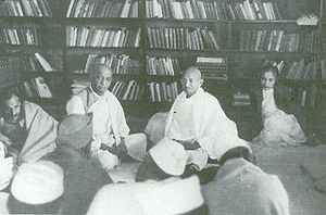 Mohandas K. Gandhi attends a Congress Working Committee meeting at Anand Bhavan. Vallabhbhai Patel is to his left, Vijaya Lakshmi Pandit to his right. January 1940. Gandhi Patel 1940.jpg