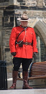 A Royal Canadian Mounted Police officer photographed from a low angle looks more imposing. Mountie-on-Parliament-Hill.jpg