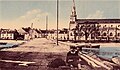 Le pont de Riantec sur l'estuaire du Riant, donnant accès à la presqu'île de Kerner, et l'église paroissiale Sainte-Radegonde, vers 1930 (carte postale colorisée).