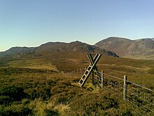 Looking along the ridge towards Pen y Graig Gron and Creigiau Gleision. The presence of a style is not necessarily an indication of a good path! Cefn Cyfarwydd style.jpg