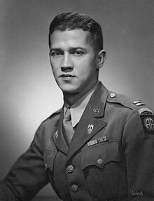 A Caucasian man with brown hair in a military uniform