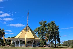 The Wisconsin Pavilion, a structure with a pointed golden roof, which has since been relocated to Wisconsin