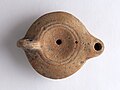 Lamp with a rounded beak found in the excavations of Lambessa in 1880.