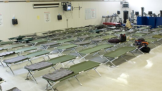 Very similar beds, but with aluminum frames and a lighter, less taut cloth, in a Red Cross shelter in 2009