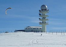 A large concrete tower with a radio dome on top