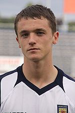 A young man wearing a white shirt