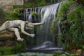 One of the Ladies reaching out for something, in front of part of the water cascade