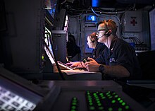 OS3 Eric Rand scans for air contacts aboard USS Iwo Jima, November 2017.jpg