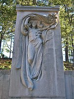 Stone pillar with a carved inlay of a female figure