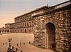 An early, tinted 20th-century photograph of the Palazzo Pitti