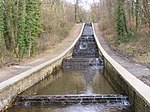 a cascade waterfall with paths on either side