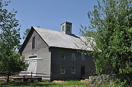 Timber framed with the sheathing covered in clapboards. New Hampshire, U.S.A.