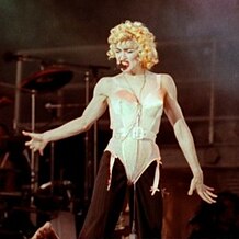 Photograph of a woman with blond hair performing on a stage