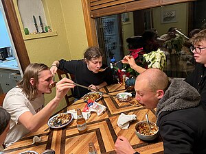 Four young men reenact the allegory Long spoons modern.jpg