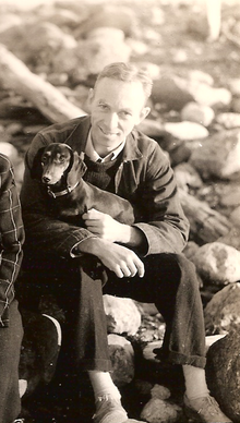 White on the beach with his dog Minnie