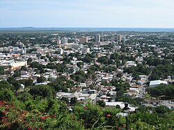 Ponce as seen from El Vigia, with the بحیرہ کیریبین and Caja de Muertos in the background