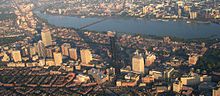 A cityscape including a number of skyscrapers, with a river running through the middle