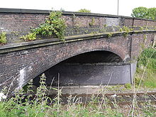 A brick segmental arch skew bridge with six rings and brick quoins Hoole Lane Bridge.jpg