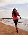 A tourist running on the island beach