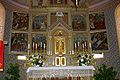 A white cloth and lace overlay on an ornate gilded altar