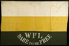 A banner composed three vertical stripes, the lowest of which has "WFL Dare to be Free" written on it