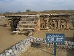 Remains of a Buddhist stupa and an information board in front