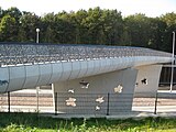 Klimopbrug over de weg en het spoor, die beide delen van het Noorderpark verbindt