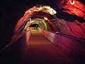 Crystal Valley, a tunnel with crystals in the wall and roof, illuminated by colourful lights. These crystals combined with the colourful lights make up for an spectacular display of lights and colours