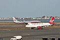 An American Airlines plane and a Virgin America plane at the airport.