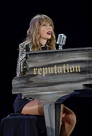 Swift singing while playing a piano